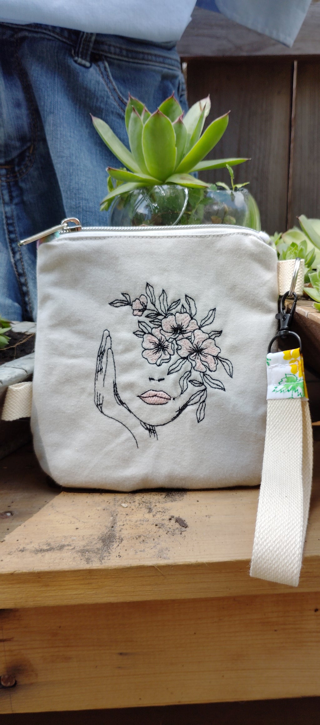 Embroidered wristlet festival flowers and face